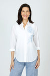 Elliott Lauren Embroider Me Shirt in White.  White pointed collar button down blouse with delicate sky blue floral and leaf embroidered motif on left side.  Long sleeve with button cuff.  Shirt tail high low hem with side inset.  Relaxed fit._t_60267567677806