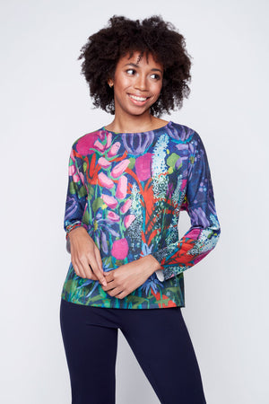 Claire Desjardins Fragrance & Flowers Sweater.  Multi stylized flowers on a purple background.  Crew neck long sleeve sweater with rib trim at neck hem and cuff.  Relaxed fit._34619271315656