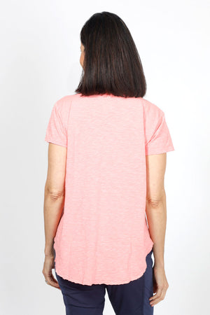 Mododoc Short Sleeve V Neck with Curved Hem in Coral Essence. V neck short sleeve high low tee. Raw edges. Relaxed fit._34970779287752