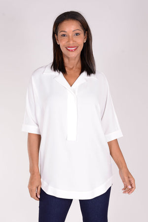 Perlavera Pino Tunic in White. Pointed spread collar with hidden button placket. Short cuffed sleeve. Below hip length. One size fits many. Boxy fit._34324080591048