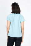 Mododoc Ruffle Henley Swing Tee in Aqua Dreams. Crew neck with open v placket. Raglan short sleeve. Ruffle at neck. Swing shape. Raw edges. Relaxed fit._t_35299707027656