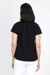 Mododoc Ruffle Henley Swing Tee in Black. Crew neck with open v placket. Raglan short sleeve. Ruffle at neck. Swing shape. Raw edges. Relaxed fit._t_35299706765512