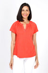 Mododoc Ruffle Henley Swing Tee in Fiery Tangerine. Crew neck with open v placket. Raglan short sleeve. Ruffle at neck. Swing shape. Raw edges. Relaxed fit._t_35299706831048