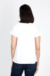 Mododoc Ruffle Henley Swing Tee in White. Crew neck with open v placket. Raglan short sleeve. Ruffle at neck. Swing shape. Raw edges. Relaxed fit._t_35299706798280