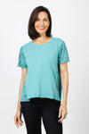 Mododoc Mixed Media Shirred Tee in Open Water. Solid front with sketched black flower and vine pattern on sleeves and back.  Crew neck with short puffed sleeve.  Side seams wrap to front.  Raw edge at sleeve and hem.  High low hem. Relaxed fit._t_60036906549614
