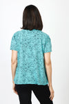 Mododoc Mixed Media Shirred Tee in Open Water. Solid front with sketched black flower and vine pattern on sleeves and back.  Crew neck with short puffed sleeve.  Side seams wrap to front.  Raw edge at sleeve and hem.  High low hem. Relaxed fit._t_60036906516846
