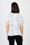 Mododoc Mixed Media Shirred Tee in White. Solid front with sketched black flower and vine pattern on sleeves and back.  Crew neck with short puffed sleeve.  Side seams wrap to front.  Raw edge at sleeve and hem.  High low hem. Relaxed fit._t_60036906615150