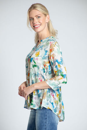 APNY Water Patch Tassel Top. Multi blue and orange splash print on a cream background. Banded crew neck with attached tassel ties. 3/4 flowing sleeve. Swing shape. Relaxed fit._34808713347272