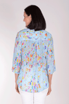 APNY Splash Tassel Top in Aqua with bright splashes of color. Crew neck with split v in front with attached tassels. 3/4 sleeve. Relaxed fit._t_34378414063816