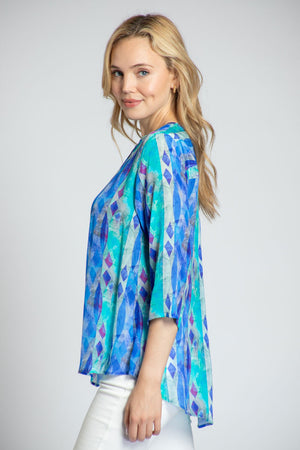APNY Diamond Tassel Top in Blue Multi. Gradient vertical stripes with inset diamond pattern. Crew neck with split front with attached tassel ties. Banded collar. 3/4 flowy sleeve. Flutter hem. Relaxed fit._34953897803976