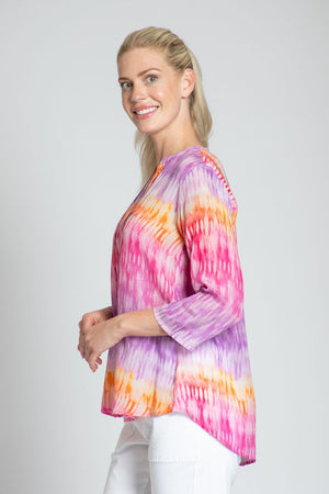 APNY Gradient Tassel Top. Pink and purple gradient stripe on a white background. Tie dye effect. Banded crew neck with attached tassel tie. 3/4 sleeve Swing shape. Relaxed fit._34808719409352