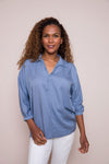 Suzy D Bonny Button Back Top in Jeans.  Pointed collar split v shirt with center seam.  Dolman 3/4 sleeve with button cuff.  Soft side gathers.  Back yoke with button detail down center back.  High low hem.  Slightly oversized fit._t_34225099276488