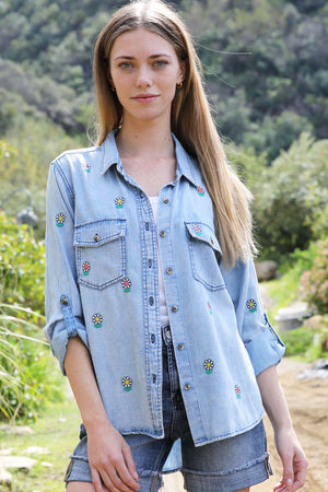 Billy T Flower Denim Shirt in light denim.  Button down shirt with embroidered multi colored flowers front and back.  2 front patch pockets with button flaps.  Long sleeve with button cuff.  Button roll tab on sleeves.  High low hem.  Side slits.  Relaxed fit._34229089435848