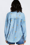 Billy T Citrus Embroidered Shirt in Denim. Refined denim shirt with embroidered oranges, on front back and sleeves. Pointed collar button down with long sleeves and button cuff. 2 front patch pockets. Back yoke. Dropped shoulder. Relaxed fit._t_34331151007944