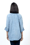 Billy T The Good Shirt in Denim. Pointed collar button down soft denim shirt. Raglan seam with doubled seam detail. Long sleeve with button cuff and roll tab closure. High low shirt tail hem. Relaxed fit._t_34518592061640