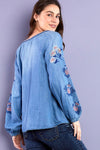 Billy T Cleo Embroidered Top in Denim. Peasant style top. Crew neck with split v placket. Raglan 3/4 sleeve with elastic cuff. Small floral embroidery around neckline, placket and raglan seams. Large floral embroidery on sleeves. Relaxed fit._t_35298644164808