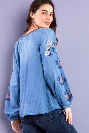 Billy T Cleo Embroidered Top in Denim. Peasant style top. Crew neck with split v placket. Raglan 3/4 sleeve with elastic cuff. Small floral embroidery around neckline, placket and raglan seams. Large floral embroidery on sleeves. Relaxed fit._35298644164808