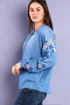 Billy T Cleo Embroidered Top in Denim. Peasant style top. Crew neck with split v placket. Raglan 3/4 sleeve with elastic cuff. Small floral embroidery around neckline, placket and raglan seams. Large floral embroidery on sleeves. Relaxed fit._t_35298644263112