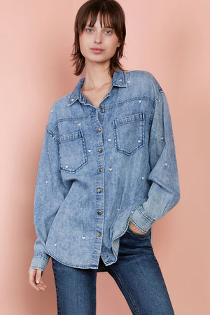 Billy T Lovely Shirt in Denim.  Soft cotton/microfiber denim shirt with distressed wash.  Miniature embroidered hearts throughout.  Pointed collar button down with long sleeves and button cuffs.  2 front patch pockets.  Front & back yoke. Curved high/low hem.  Relaxed fit._34940319400136