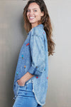 Billy T Wild Flower Embroidered Shirt in Denim. Pointed collar button down denim shirt with wildflower embroidery. Long sleeves with button cuff and roll button tab. Curved high low hem. Frayed hem. Back yoke. Relaxed fit._t_35298570993864