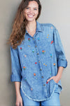 Billy T Wild Flower Embroidered Shirt in Denim.  Pointed collar button down denim shirt with wildflower embroidery.  Long sleeves with button cuff and roll button tab.  Curved high low hem.  Frayed hem.  Back yoke.  Relaxed fit._t_35298570895560