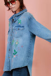 Billy T Hanging Plant Shirt in Denim blue. Midweight hybrid shirt/jacket. Pointed collar button down shirt with long sleeve and button cuffs. 2 front button flap patch pockets. Back yoke. High low hem. Relaxed fit._t_35042070528200