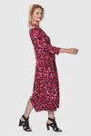 Alembika Begonia Cocoon Dress. Pink and red petal print on a black background. V neck midi dress with a high neck in back. 3/4 sleeve Dropped waist. Bubble skirt. 2 in seam pockets. Relaxed fit._t_34703985475784