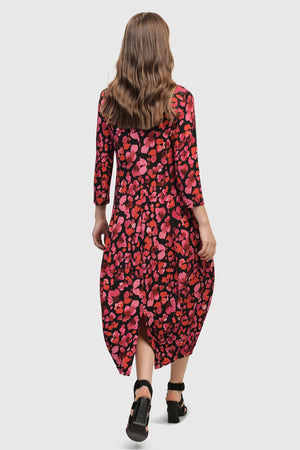 Alembika Begonia Cocoon Dress. Pink and red petal print on a black background. V neck midi dress with a high neck in back. 3/4 sleeve Dropped waist. Bubble skirt. 2 in seam pockets. Relaxed fit._34703985574088