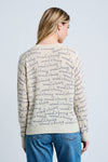 Lisa Todd Normal is Boring Cashmere Sweater in Winter White.  Crew neck long sleeve sweater with screen print "normal is boring" slogan throughout.  Embroidered slogan in black at lower right.  Rib trim at neck, hem and cuff.  Classic fit._t_61210145620334