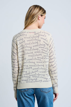 Lisa Todd Normal is Boring Cashmere Sweater in Winter White.  Crew neck long sleeve sweater with screen print "normal is boring" slogan throughout.  Embroidered slogan in black at lower right.  Rib trim at neck, hem and cuff.  Classic fit._61210145620334