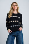 Lisa Todd Love Tracks Sweater in Black with 1 row each of white, beige and gray intarsia hearts.  Cotton/cashmere pullover crew neck sweater.  Long sleeves with dropped shoulders.  Intarsia hearts in front and sleeves.  Plain back.  Blanket stitch trim at cuffs. Rib trim at neck hem and cuff.  Classic fit._t_61429884518766