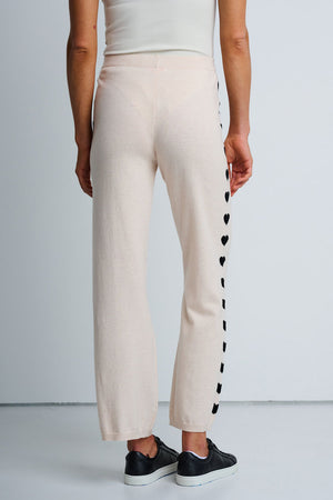 Lisa Todd Heart Track Pant in Sheepskin.  1 1/4" elastic waist pull on cotton/cashmere pant.  Black intarsia hearts down the side of each leg.  Straight leg.  Snug through stomach and hip, straight to hem. Rib trim at hem.  10 1/4" leg opening; 28" inseam._61429933048174