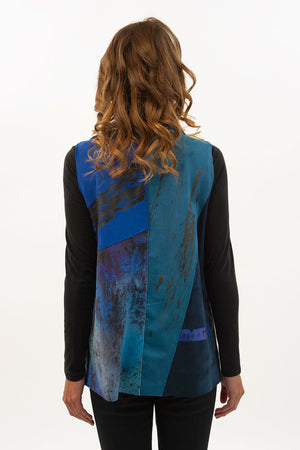 Lemon Grass Ultrasude Handprint Vest in Navy Multi. Handprinted washable suede vest in shades of blue. Convertible collar hidden zip front vest with large snap closure. Patchwork construction. 2 front patch pockets with grommet detail. Relaxed fit._34641258479816