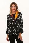 Lemon Grass Mustard Reversible Crepe Jacket. Abstract mustard, red. black and white print reverses to a black and white scribble print. Mandarin collar 1 button jacket with black and white novelty buttons. 3/4 sleeve. 2 front patch pockets. Relaxed fit._t_34641246027976