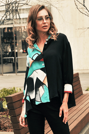 Lemon Grass Abstract Aqua Mixed Media Blouse.  Aqua black and white abstract print on 1/2 of blouse, solid black on the other. Pointed collar button down with half hidden button placket.  3/4 sleeve with button cuff.  Center back seam with open vent at hem.  Side slits. A line shape; relaxed fit._34446975434952