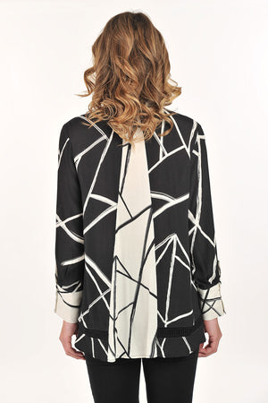 Lemon Grass Stand Collar Eyelet Trim Blouse in Black/Cream.  Black and cream abstract line print with reverse color trim.  Stand collar button down blouse with pairs of buttons.  Long sleeves with double button cuff.  Reverse print inset down center back.  Eyelet ribbon detail.  High low hem.  Side slits.  Relaxed fit._61407833653614