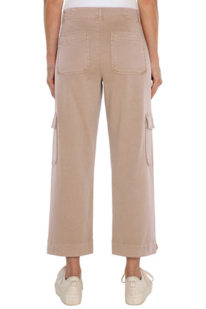 Liverpool Utility Cargo Crop in Biscuit Tan. Mid-rise pant with 2 button closure. 2 front utility stitched pockets, 2 side button flap cargo pockets and 2 rear patch pockets. Button tab at hem. 26" inseam._35048636547272