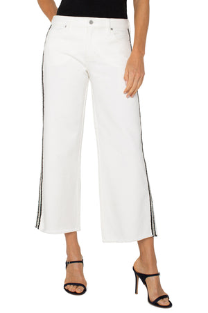 Liverpool Embroidered Stride High Rise Wide Leg Crop Jean, a white wash with black embroidered braid at sides.  9" rise 5 pocket jean with button waist and zipper closure.  Belt loops.  Leg seam detail.  20" leg opening, 26" inseam._60102263570798