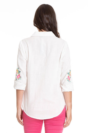 APNY Floral Embroidered Blouse. Multi colored embroidered floral on a white background. Long sleeves with button cuff and roll button tab. Jacquard chevron pattern detail on front. Plain back. Hot pink edging on button holes. Shirt tail hem with raw edge. Relaxed fit._34247781843144