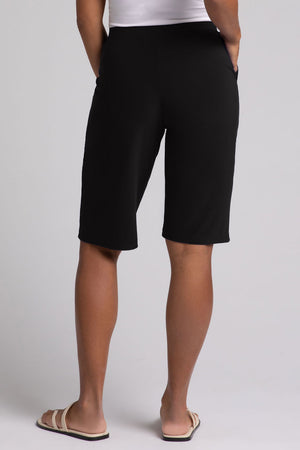 Sympli Nu Straight Leg Short in Black. 1 1/2" stretch waistband. 2 front slash pockets. Leg falls straight from hip. 11 1/2" inseam._35035465482440