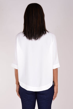 Perlavera Pino Shirt in White. Popover with pointed spread collar, and hidden button placket. Short cuffed sleeves. Curved hem. One size fits many. Boxy fit._34324057817288