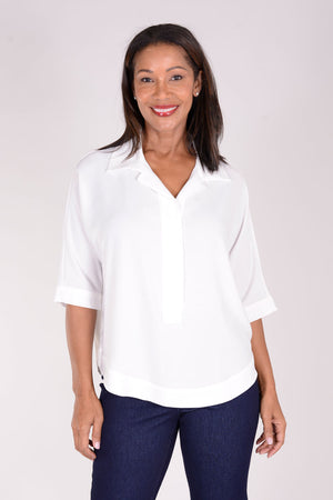 Perlavera Pino Shirt in White. Popover with pointed spread collar, and hidden button placket. Short cuffed sleeves. Curved hem. One size fits many. Boxy fit._34324057882824
