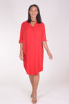 Perlavera Dina Dress in Red. Below the knee popover dress with pointed spread collar, hidden button placket and short cuffed sleeves. Curved high low hem. In seam pockets. One size fits most._t_34324036026568