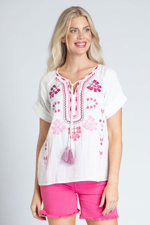 APNY Short Sleeve Embroidered Top in White with pink embroidery on front and placket.  Crew neck with split v and tassel tie.  Short sleeves.  Straight hem. Relaxed fit._35228885811400