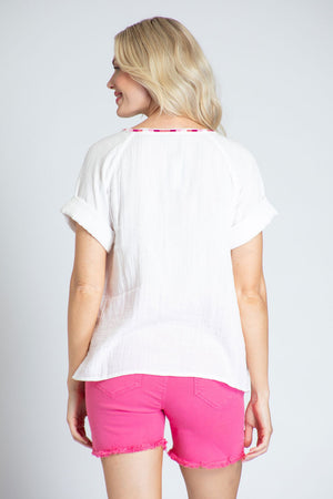 APNY Short Sleeve Embroidered Top in White with pink embroidery on front and placket. Crew neck with split v and tassel tie. Short sleeves. Straight hem. Relaxed fit._35228885778632