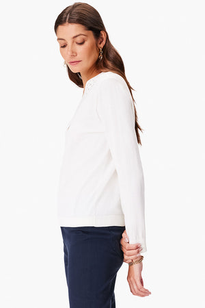 NIC+ZOE Polished Up Sweater in Cream. V neck long sleeve sweater with geometric cut out inset placket around neckline. Rib trim at cuff and hem. Classic fit._35077498667208
