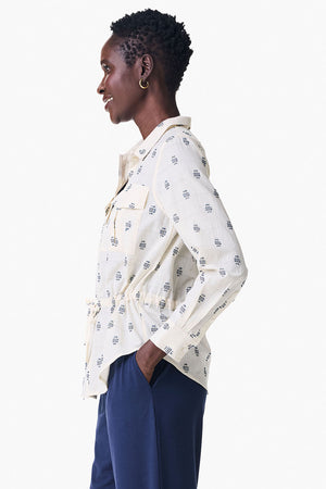 NIC+ZOE Constellation Jacket in Cream with navy miniature print. Pointed collar button down hybrid shirt jacket. Long sleeves with button cuffs. Back yoke. Shirt tail hem. Cinch tie at waist. Relaxed fit._35249431871688