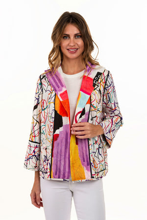 Lemongrass Reversible Classic Crepe Jacket. Shades of red, orange, pink, black and white abstract print reverses to bright splatter print on white. Open front jacket with convertible collar and 3/4 bell sleeve. Boxy fit_34330919239880