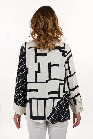 Lemon Grass Mixed Media Blouse with Back Detail in Black and Cream. Mixed geometric prints. Button down with solid crew stand collar and cuffs. Novelty rounded metal buttons. Long sleeves with cufflink cuff closure. Cross over fabric at back hem. Relaxed fit._35061510602952