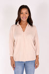 Suzy D Bonny Button Back Top in pale Pink. Pointed collar split v shirt with center seam. Dolman 3/4 sleeve with button cuff. Soft side gathers. Back yoke with button detail down center back. High low hem. Slightly oversized fit._t_34236644557000